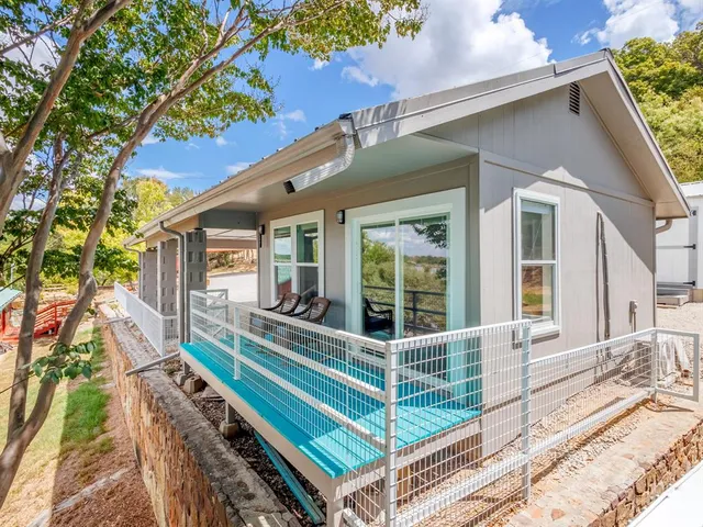 a view of a house with a backyard and balcony