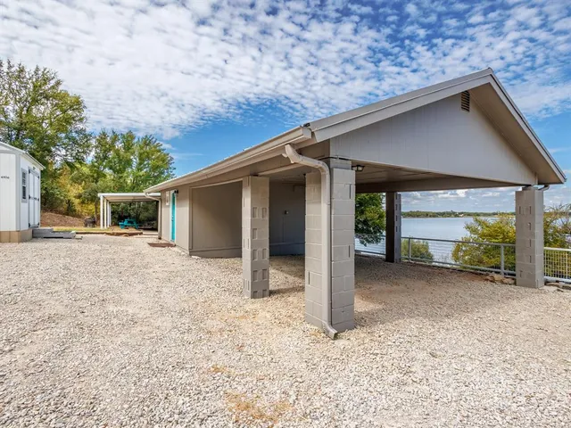 a backyard of a house with table and chairs