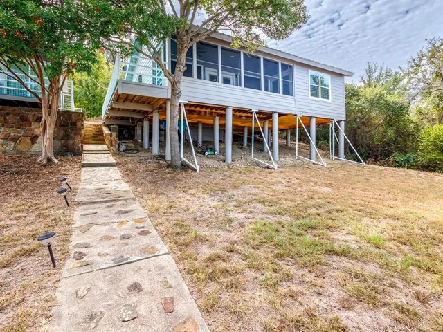 a view of a house with backyard porch and sitting area