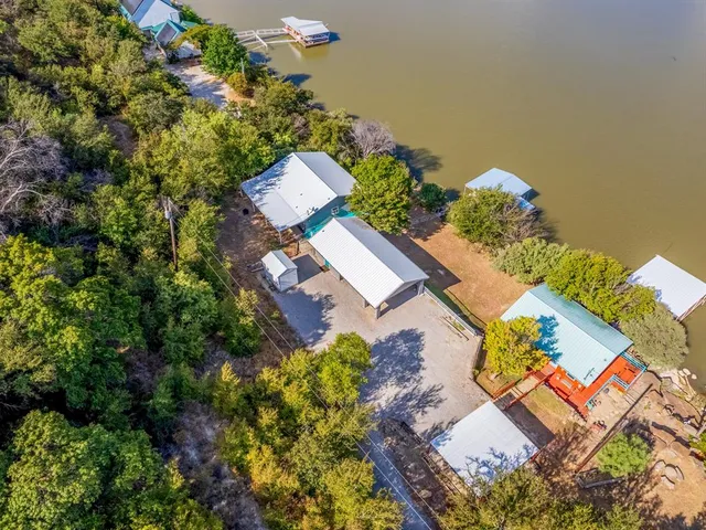 an aerial view of a house with a yard and garden