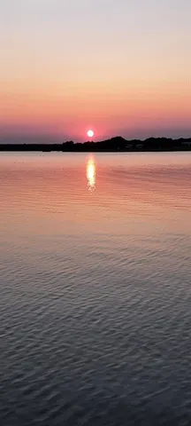 a view of lake and sunset