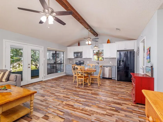 a dining room with furniture and wooden floor