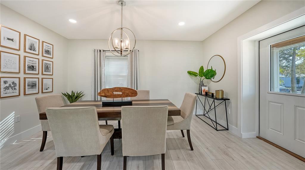 1901 Morrill Street Sarasota, FL 34236 - Photo 12 of 50 a dining room with furniture a potted plant and wooden floor