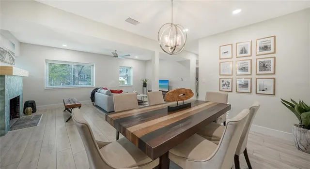 a living room with furniture kitchen view and a large window