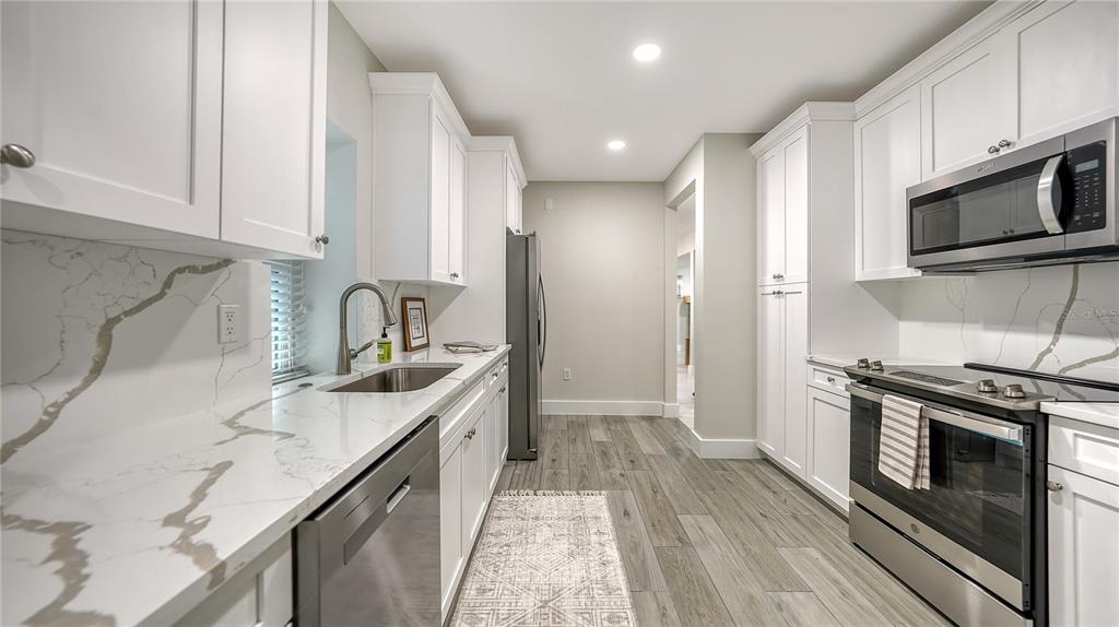 1901 Morrill Street Sarasota, FL 34236 - Photo 15 of 50 a kitchen with stainless steel appliances granite countertop a sink stove and refrigerator