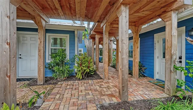 a view of a brick house with potted plants