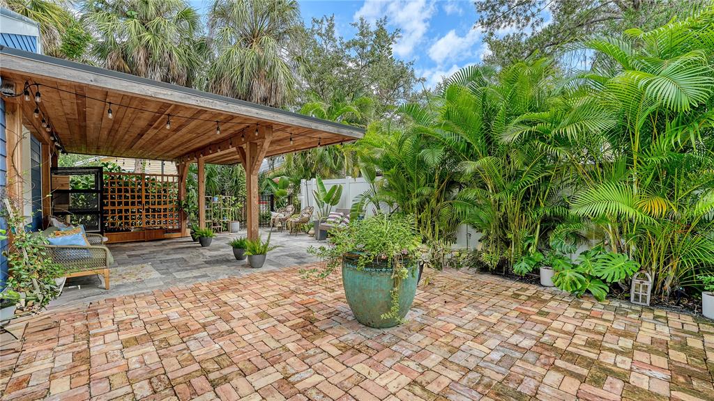 1901 Morrill Street Sarasota, FL 34236 - Photo 32 of 50 a view of a patio with table and chairs potted plants with wooden fence