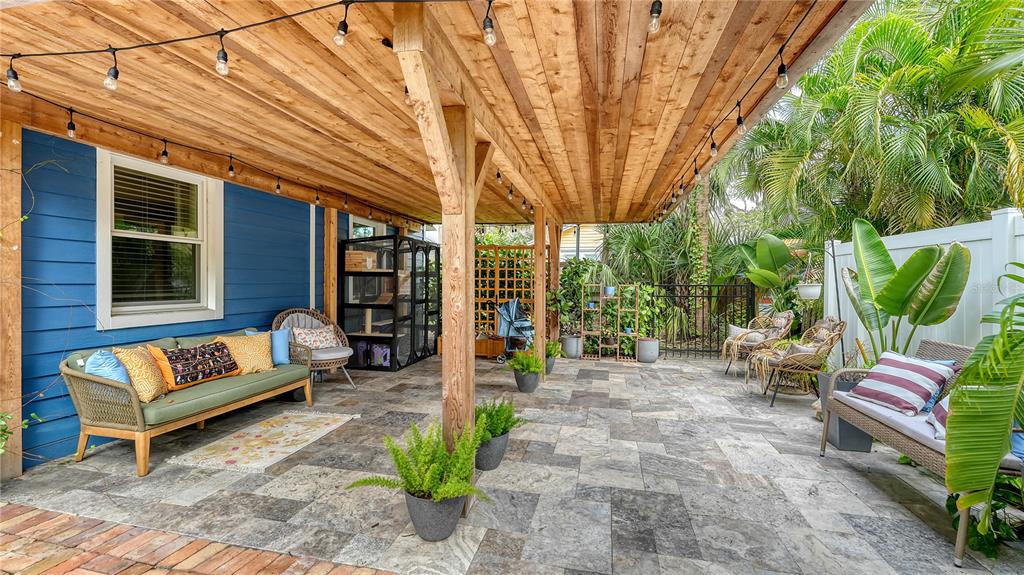 1901 Morrill Street Sarasota, FL 34236 - Photo 33 of 50 a view of a patio with couches and chairs under an umbrella