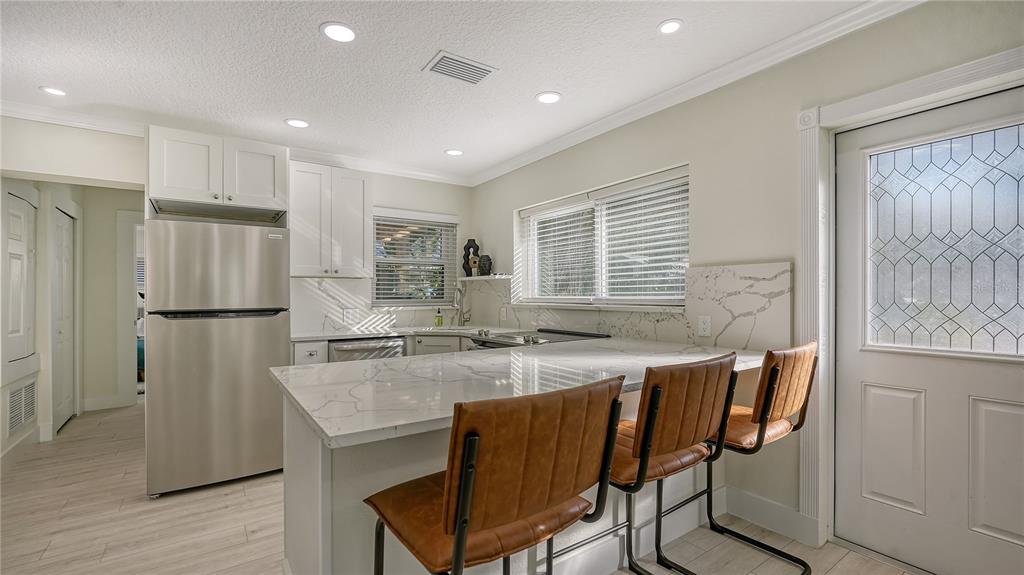 1901 Morrill Street Sarasota, FL 34236 - Photo 37 of 50 a kitchen with stainless steel appliances granite countertop a table chairs sink refrigerator and cabinets