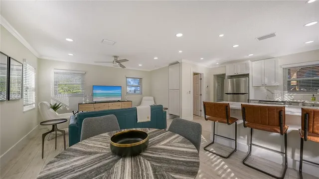 a living room with furniture a dining table and kitchen view