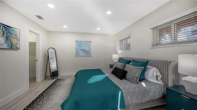 a bed room with a bed and a painting