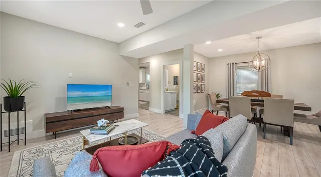 a living room with furniture and wooden floor