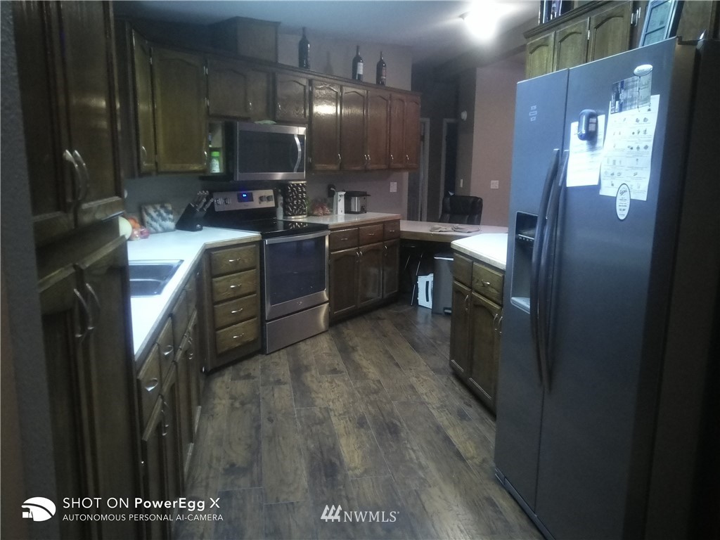 6618 Kickerville Road Ferndale, WA 98248 - Photo 17 of 30 a kitchen with cabinets and stainless steel appliances