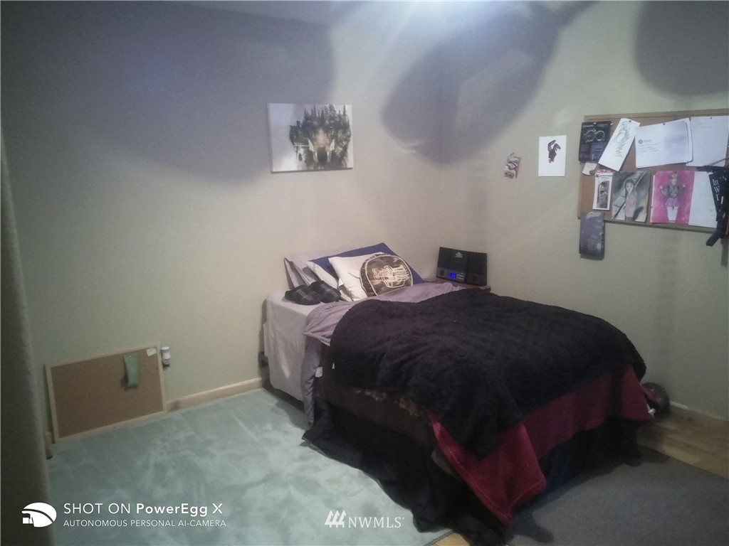 6618 Kickerville Road Ferndale, WA 98248 - Photo 19 of 30 a bedroom with a bed and wall painting