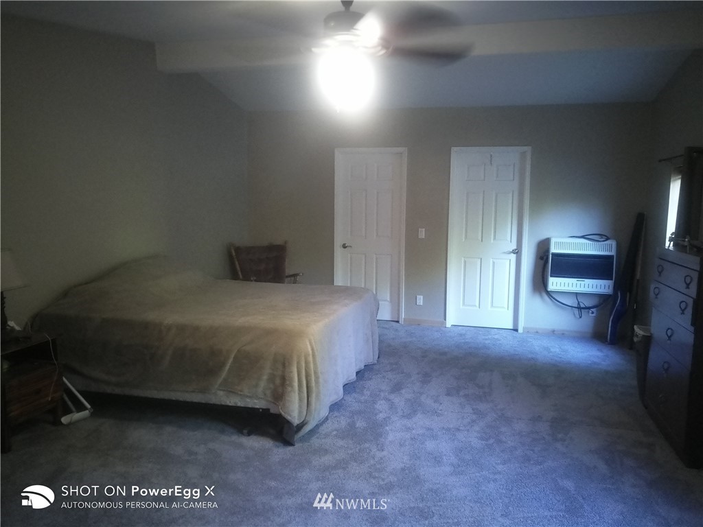 6618 Kickerville Road Ferndale, WA 98248 - Photo 8 of 30 a spacious bedroom with a bed and a view of balcony
