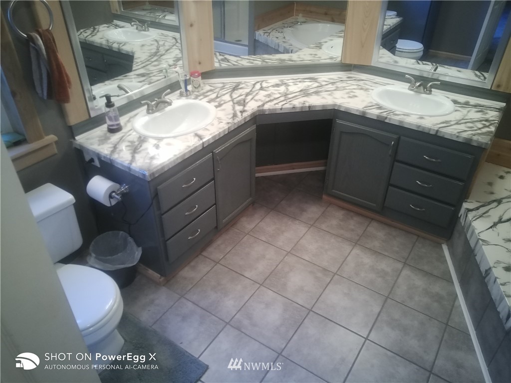 6618 Kickerville Road Ferndale, WA 98248 - Photo 9 of 30 a bathroom with a sink vanity and mirror