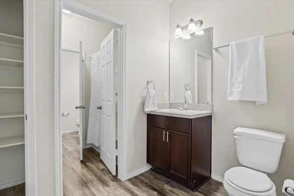 a bathroom with a toilet a sink and a mirror