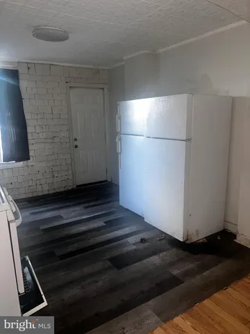 a view of a closet area with wooden floor