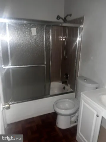 a bathroom with a toilet a sink and shower