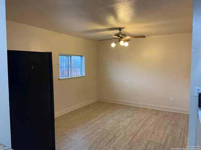 a bathroom with a granite countertop toilet sink and mirror