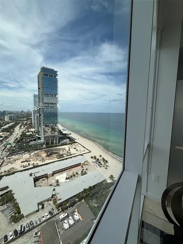 a living room with couch next to a large window