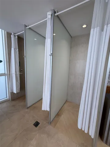 a view of a swimming pool with lawn chairs and couches