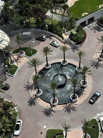 a view of a backyard with plants and outdoor seating