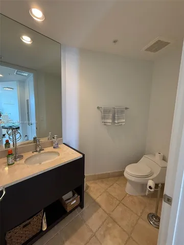 a kitchen with stainless steel appliances granite countertop a sink a stove counter space and cabinets