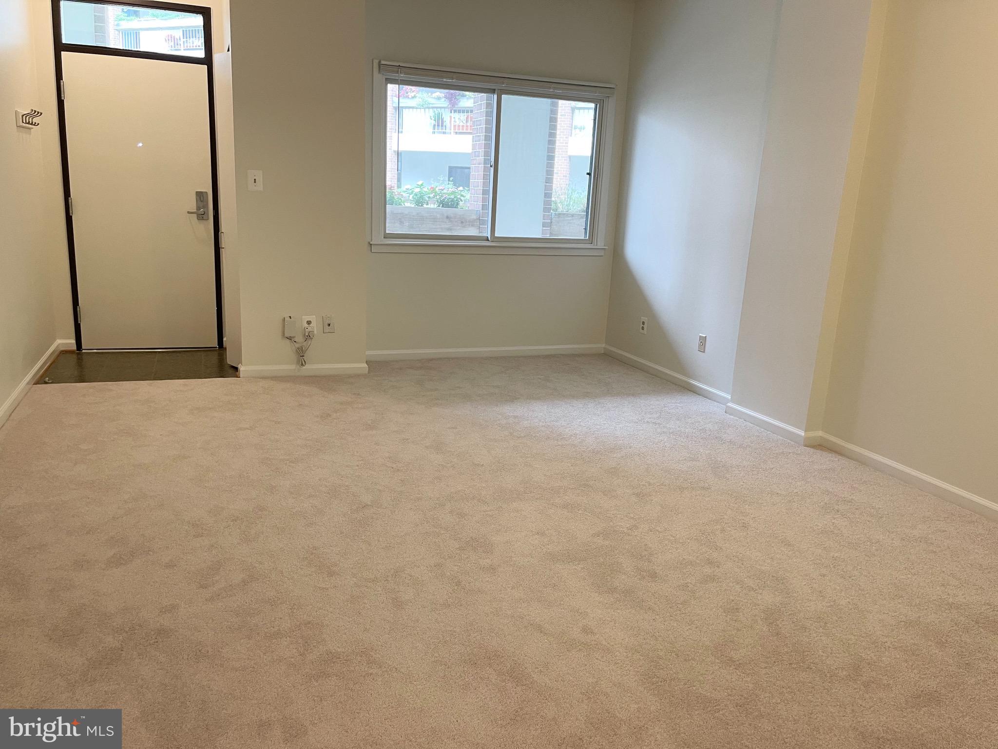 1951 Sagewood Lane, Unit 110 Reston, VA 20191 - Photo 7 of 41 Living / Dining Room w/ View to Courtyard