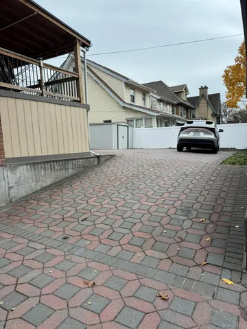 a view of a patio with table and chairs with wooden fence and plants