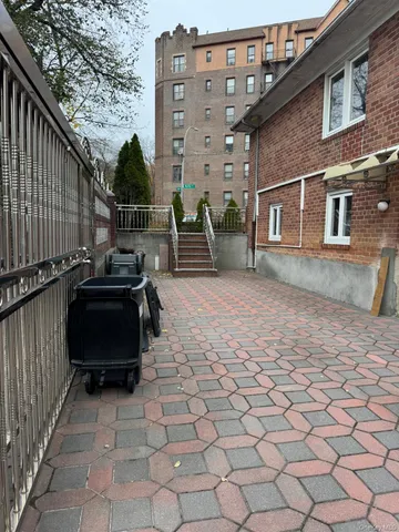 a view of a house with a yard and a car parked under a large tree