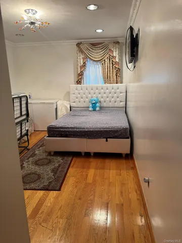 a spacious bedroom with a bed and dresser in it