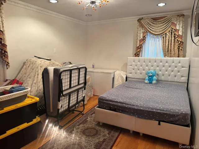 a bedroom with furniture and a wooden floor