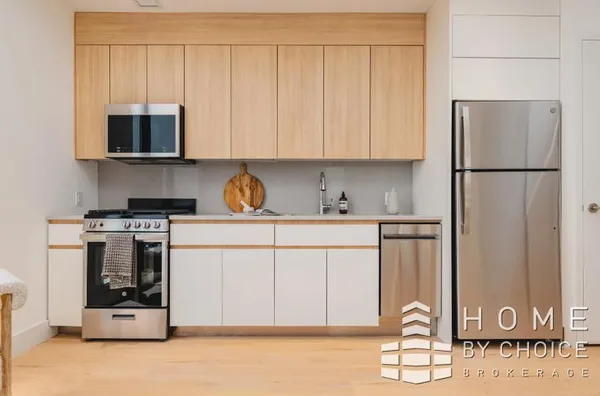 a kitchen with stainless steel appliances granite countertop a refrigerator sink and white cabinets