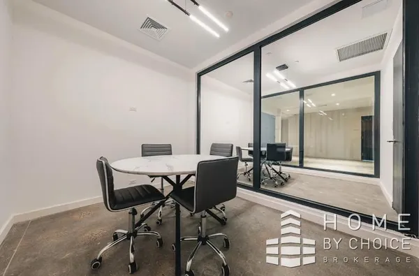 a dining room with furniture and a floor to ceiling window