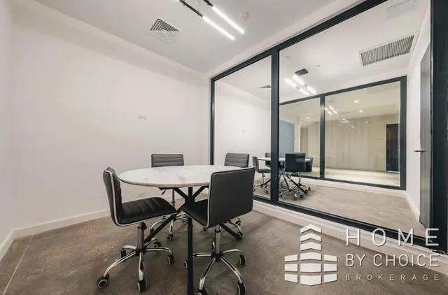 a dining room with furniture and a floor to ceiling window