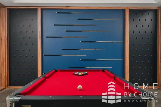 a room with pool table and window