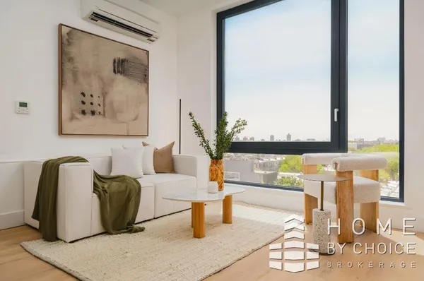 a bedroom with a bed and a dresser next to a window