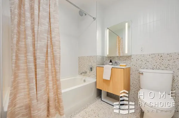 a spacious bathroom with a bathtub and shower