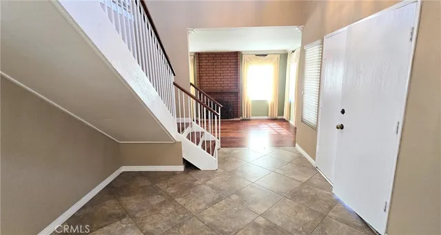 a view of a kitchen with fridge and wooden floor
