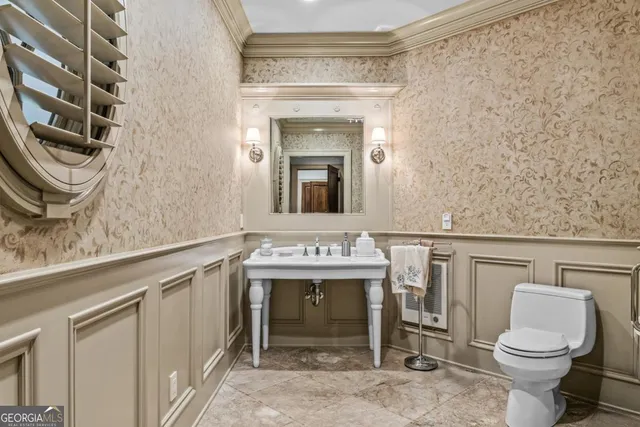 a kitchen with stainless steel appliances kitchen island granite countertop a sink dishwasher a dining table and chairs with wooden floor