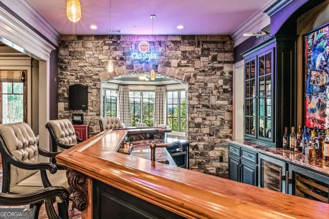 a patio with a table and chairs under an umbrella