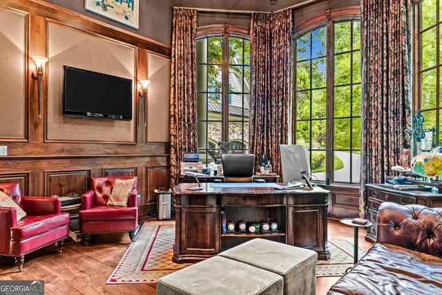 a living room with furniture a fireplace and a chandelier