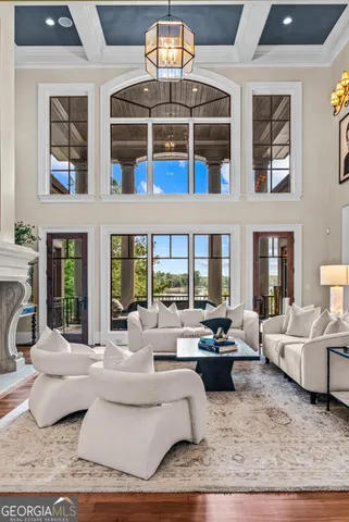 a living room with furniture or floor to ceiling windows and a potted plant