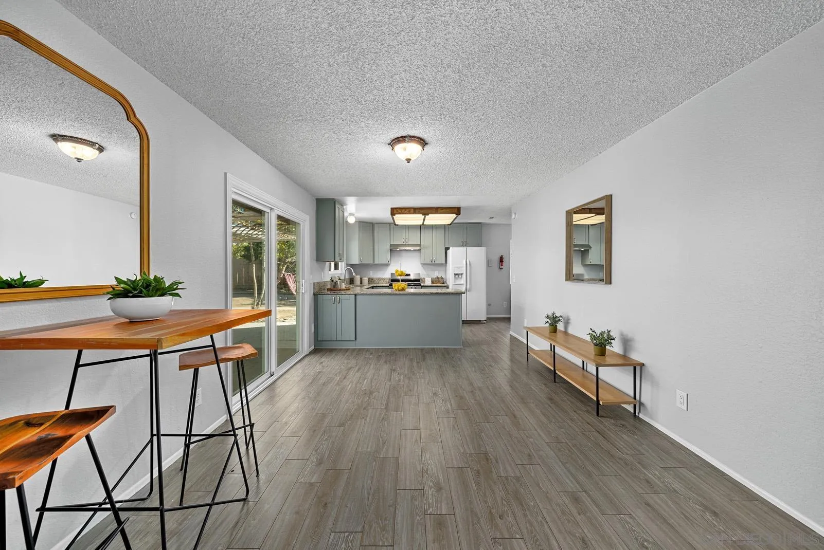 950 East Fallbrook Street Fallbrook, CA 92028 - Photo 14 of 37 a living room with stainless steel appliances kitchen island granite countertop furniture and wooden floor