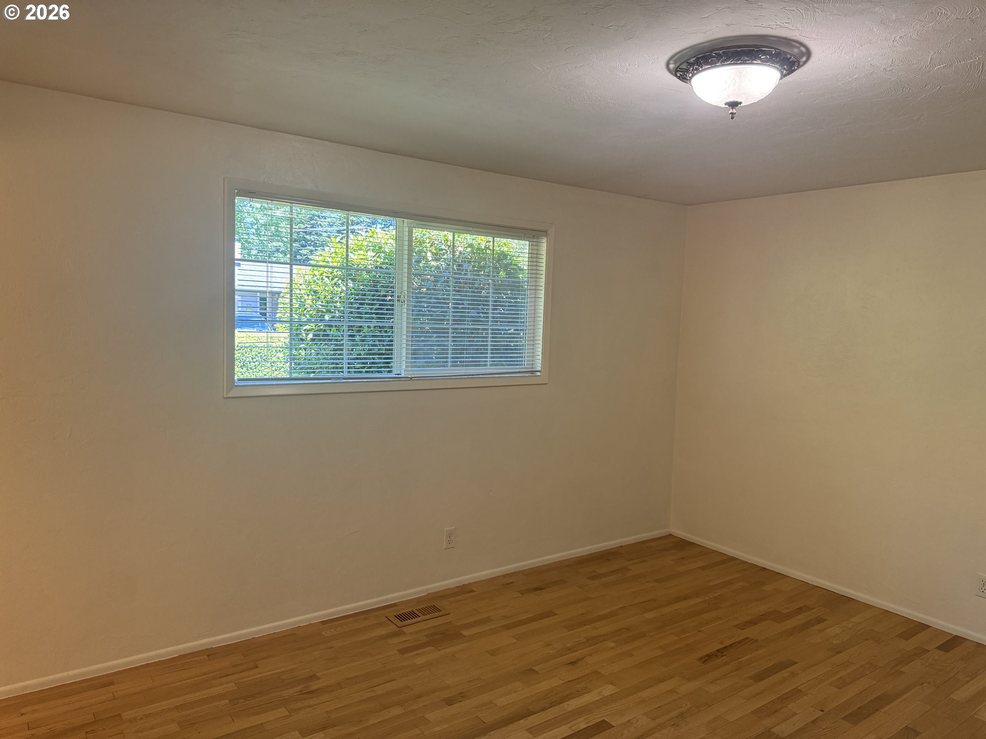 260 Susan Street Eugene, OR 97404 - Photo 18 of 33 a view of an empty room with wooden floor and a window