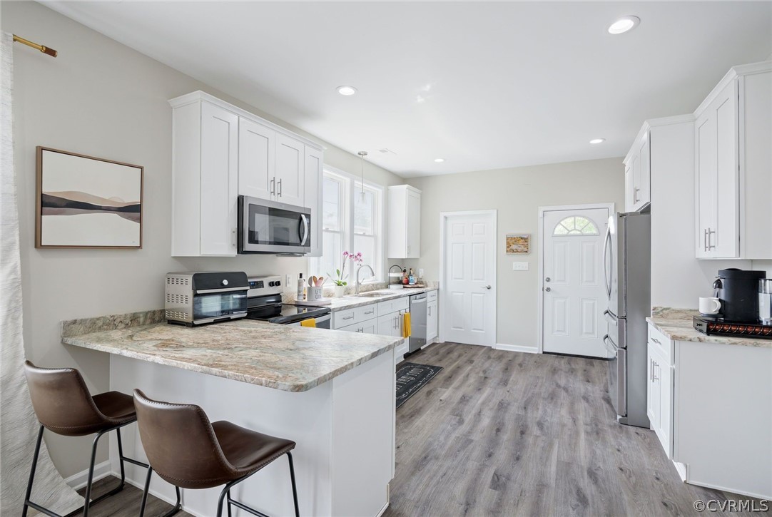 2900 Decatur Street Richmond, VA 23224 - Photo 11 of 35 a kitchen with a stove a sink and a refrigerator