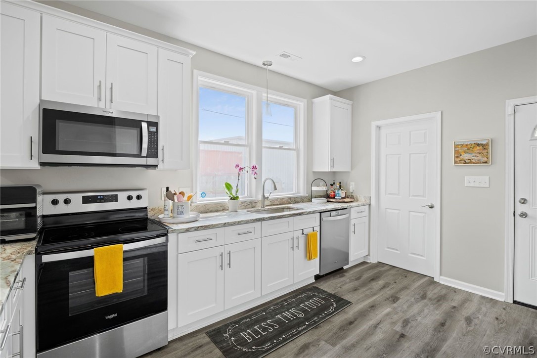 2900 Decatur Street Richmond, VA 23224 - Photo 12 of 35 a kitchen with a sink stove and microwave