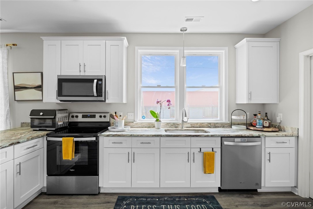 2900 Decatur Street Richmond, VA 23224 - Photo 13 of 35 a kitchen with stainless steel appliances granite countertop a stove a sink and a microwave