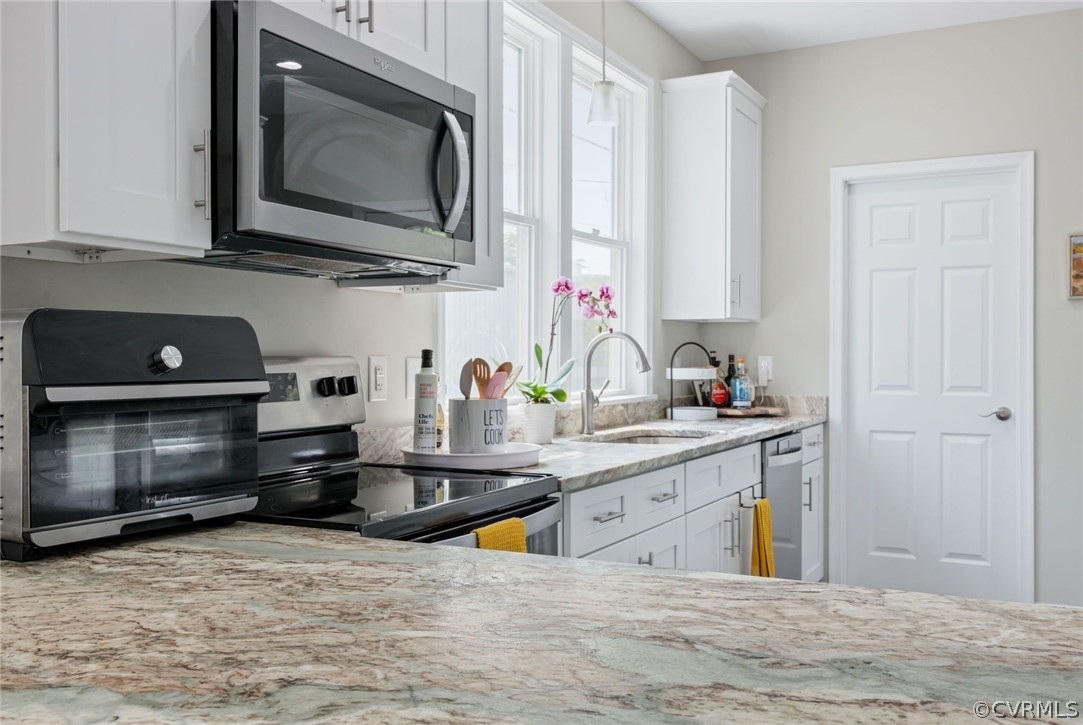 2900 Decatur Street Richmond, VA 23224 - Photo 15 of 35 a kitchen with stainless steel appliances white cabinets and a sink